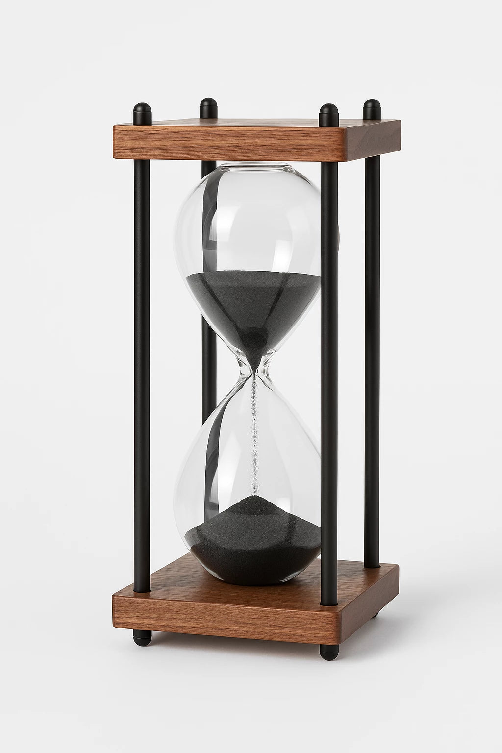 Hourglass with wooden base and black sand on a white background